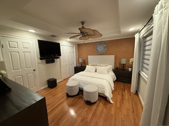 44 Fawn Hill Rd, Shelton, CT 06484 - bedroom with ornamental molding, light wood-type flooring, recessed lighting, a tray ceiling, and a closet