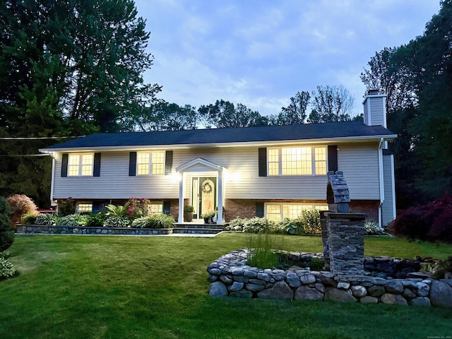 44 Fawn Hill Rd, Shelton, CT 06484 - bi-level home featuring a front yard, a chimney, and brick siding