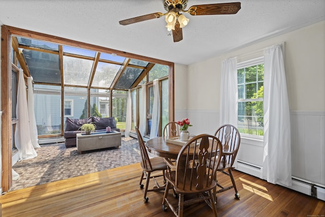 136 Bloomfield Ave, Windsor, CT 06095 - dining space featuring wood finished floors, wainscoting, a ceiling fan, a textured ceiling, and baseboard heating
