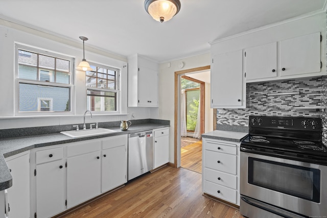 136 Bloomfield Ave, Windsor, CT 06095 - kitchen with stainless steel appliances, wood finished floors, white cabinets, tasteful backsplash, and ornamental molding
