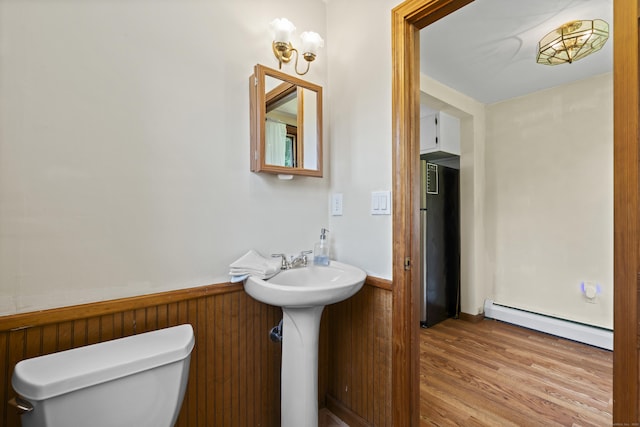 136 Bloomfield Ave, Windsor, CT 06095 - half bath with a baseboard radiator, a wainscoted wall, and wood finished floors