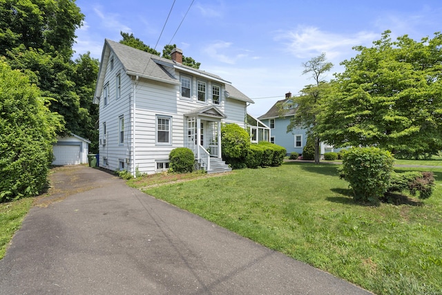 136 Bloomfield Ave, Windsor, CT 06095 - traditional-style house featuring a chimney, a front yard, an outbuilding, a garage, and driveway