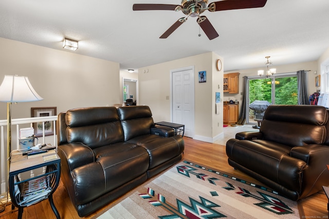 65 Norwich Westerly Rd, North Stonington, CT 06359 - living room with a ceiling fan, light wood-type flooring, and a chandelier