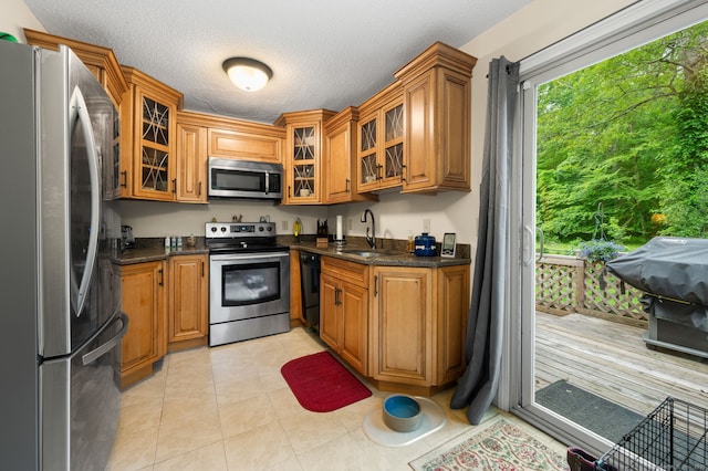 65 Norwich Westerly Rd, North Stonington, CT 06359 - kitchen featuring stainless steel appliances, brown cabinets, a textured ceiling, and glass insert cabinets