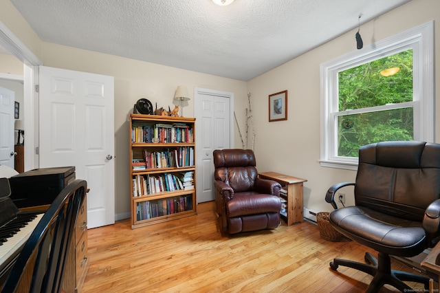 65 Norwich Westerly Rd, North Stonington, CT 06359 - sitting room featuring light wood finished floors, an office area, a textured ceiling, and baseboard heating