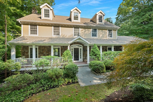 12B Hickory Dr, Greenwich, CT 06831 - view of front facade with covered porch, stone siding, roof with shingles, and a chimney