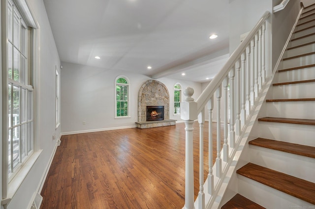 12B Hickory Dr, Greenwich, CT 06831 - unfurnished living room with a stone fireplace, wood finished floors, stairway, and recessed lighting