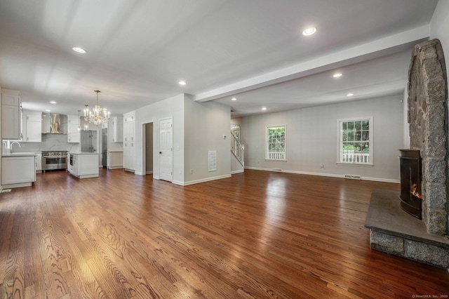 12B Hickory Dr, Greenwich, CT 06831 - unfurnished living room with a chandelier, recessed lighting, wood finished floors, and a fireplace