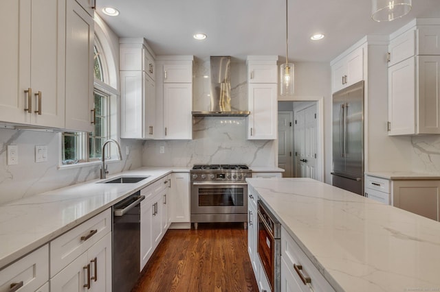 12B Hickory Dr, Greenwich, CT 06831 - kitchen featuring built in appliances, wall chimney exhaust hood, white cabinets, and recessed lighting