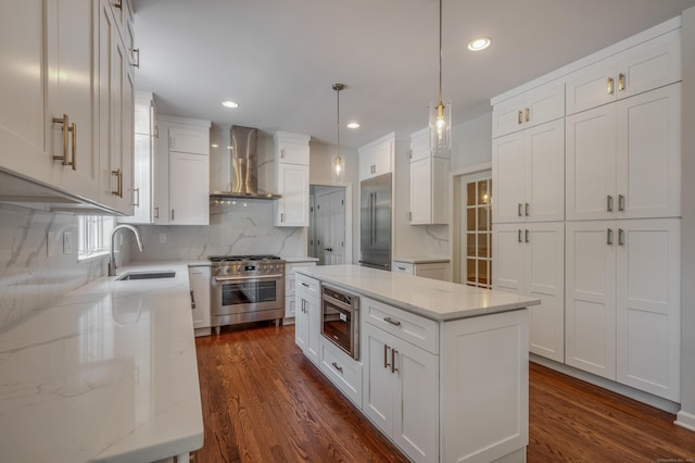 12B Hickory Dr, Greenwich, CT 06831 - kitchen featuring wall chimney exhaust hood, premium appliances, white cabinets, backsplash, and dark wood-style flooring