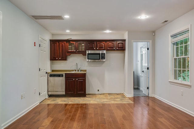 12B Hickory Dr, Greenwich, CT 06831 - kitchen featuring appliances with stainless steel finishes, light wood-type flooring, glass insert cabinets, recessed lighting, and dark brown cabinets