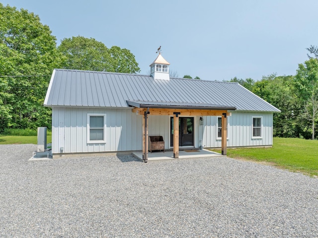 376 Rte 165, Preston, CT 06365 - view of front facade with board and batten siding, a patio, and a metal roof