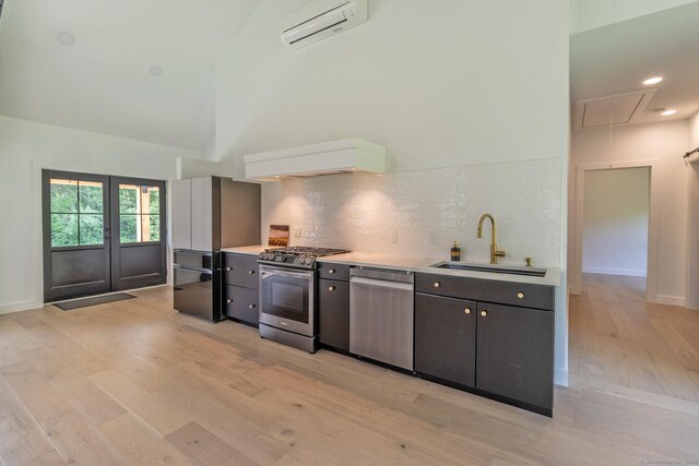 376 Rte 165, Preston, CT 06365 - kitchen featuring appliances with stainless steel finishes, an AC wall unit, custom range hood, light wood-style floors, and backsplash