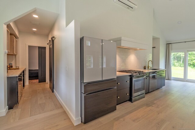 376 Rte 165, Preston, CT 06365 - kitchen featuring stainless steel appliances, high vaulted ceiling, a wall mounted air conditioner, light wood-style flooring, and decorative backsplash