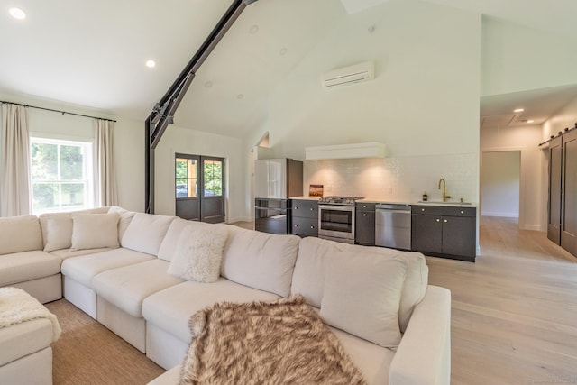 376 Rte 165, Preston, CT 06365 - living area with an AC wall unit, high vaulted ceiling, attic access, recessed lighting, and light wood finished floors