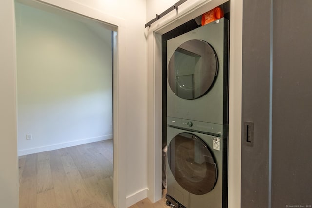 376 Rte 165, Preston, CT 06365 - washroom with stacked washing machine and dryer and light wood-style flooring