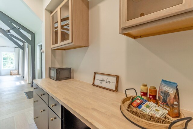 376 Rte 165, Preston, CT 06365 - kitchen with black microwave, light wood-style flooring, and glass insert cabinets
