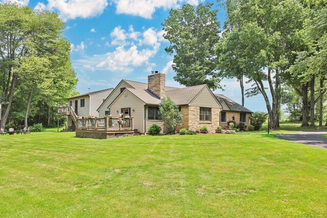1028 Mountain Rd, Suffield, CT 06093 - view of front facade with a deck, a chimney, a front yard, and stone siding