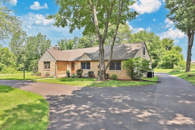 1028 Mountain Rd, Suffield, CT 06093 - view of front of home featuring a chimney, a front lawn, a shingled roof, and stone siding