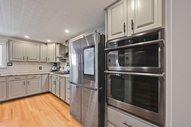 1028 Mountain Rd, Suffield, CT 06093 - kitchen featuring smart refrigerator, multiple ovens, light wood-type flooring, backsplash, and light stone counters