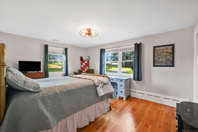 1028 Mountain Rd, Suffield, CT 06093 - bedroom featuring a baseboard radiator and light wood finished floors