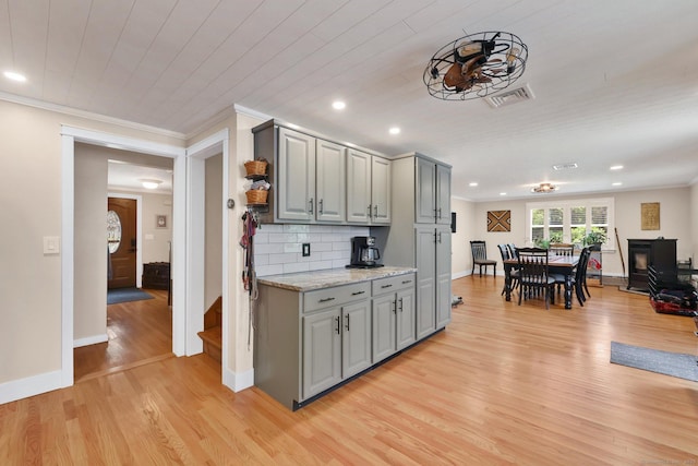 1028 Mountain Rd, Suffield, CT 06093 - kitchen with gray cabinets, light wood-style flooring, crown molding, tasteful backsplash, and recessed lighting