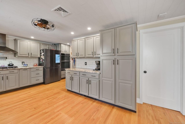 1028 Mountain Rd, Suffield, CT 06093 - kitchen featuring freestanding refrigerator, gray cabinetry, wall chimney exhaust hood, light wood-type flooring, and tasteful backsplash