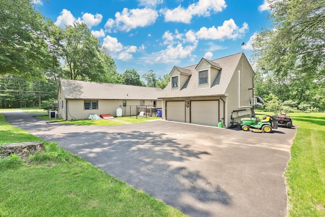 1028 Mountain Rd, Suffield, CT 06093 - cape cod home with an attached garage, asphalt driveway, roof with shingles, and a front lawn
