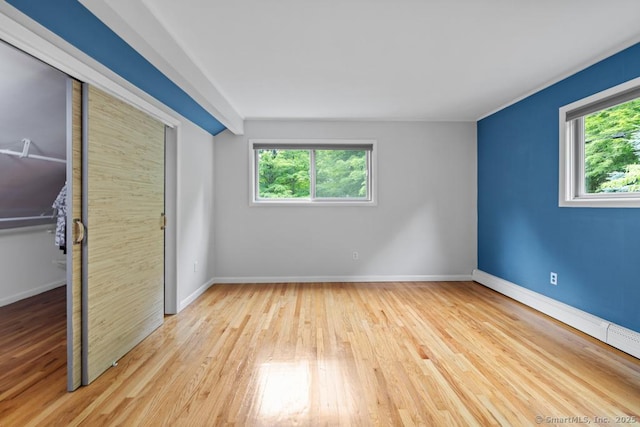 96 Pine Mountain Rd, Ridgefield, CT 06877 - unfurnished bedroom featuring multiple windows, wood finished floors, baseboard heating, and a closet