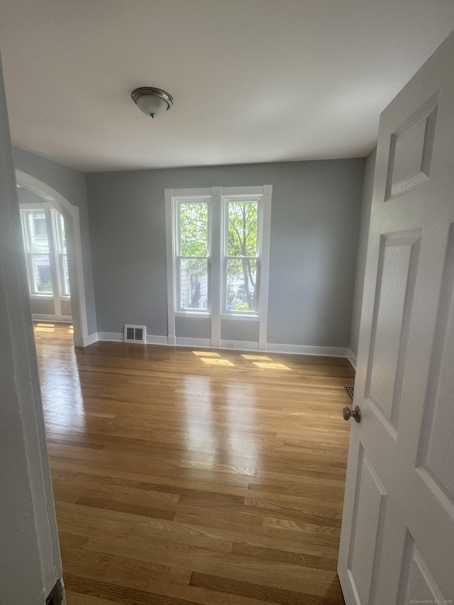 18 Pine St, Waterbury, CT 06710 - spare room with wood finished floors and arched walkways