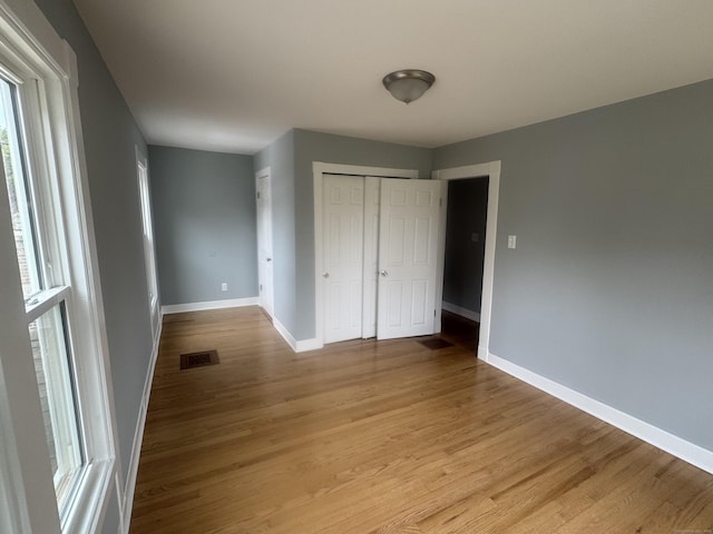 18 Pine St, Waterbury, CT 06710 - unfurnished bedroom with wood finished floors and a closet