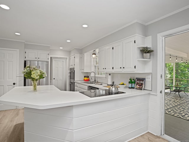 5 September Ln, Weston, CT 06883 - kitchen with stainless steel appliances, open shelves, white cabinetry, light countertops, and a peninsula
