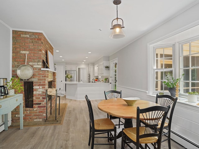 5 September Ln, Weston, CT 06883 - dining area with light wood-style floors, a baseboard radiator, ornamental molding, a brick fireplace, and recessed lighting