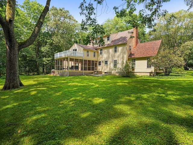 5 September Ln, Weston, CT 06883 - back of property with a sunroom, a chimney, a lawn, and a balcony