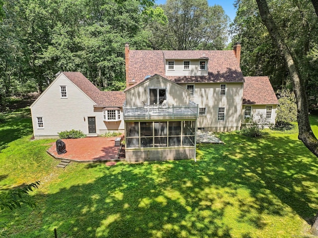 5 September Ln, Weston, CT 06883 - back of property featuring a sunroom, a chimney, a patio, a lawn, and a balcony