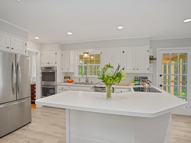 5 September Ln, Weston, CT 06883 - kitchen featuring stainless steel appliances, light wood-style flooring, crown molding, healthy amount of natural light, and white cabinets