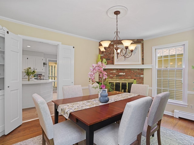 5 September Ln, Weston, CT 06883 - dining room with a chandelier, wood finished floors, crown molding, and baseboard heating