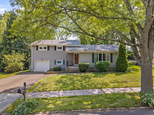 50 Carroll Rd, Hamden, CT 06517 - tri-level home featuring driveway, an attached garage, a front yard, and a chimney