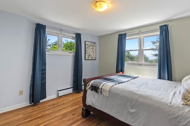 50 Carroll Rd, Hamden, CT 06517 - bedroom featuring multiple windows, wood finished floors, and a baseboard heating unit