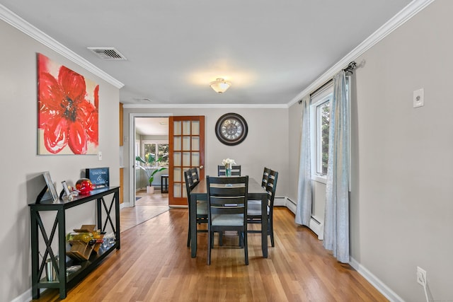 50 Carroll Rd, Hamden, CT 06517 - dining area with wood finished floors, ornamental molding, and a baseboard radiator