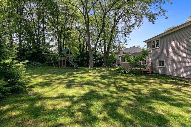 50 Carroll Rd, Hamden, CT 06517 - view of green lawn featuring a playground and a wooden deck