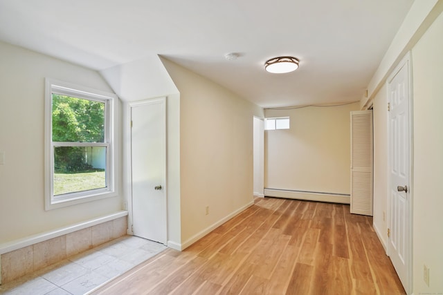 1198 New Haven Ave, Milford, CT 06460 - empty room featuring a baseboard radiator, light wood finished floors, and a smoke detector