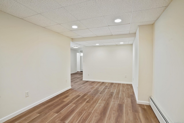 1198 New Haven Ave, Milford, CT 06460 - unfurnished room featuring a baseboard radiator, light wood-style flooring, recessed lighting, and a paneled ceiling