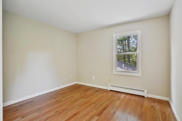 1198 New Haven Ave, Milford, CT 06460 - empty room with baseboard heating and light wood-style floors