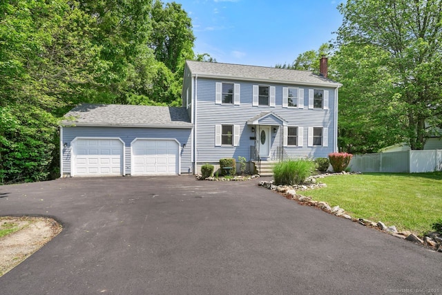 1198 New Haven Ave, Milford, CT 06460 - colonial inspired home with a chimney, a garage, asphalt driveway, and a shingled roof