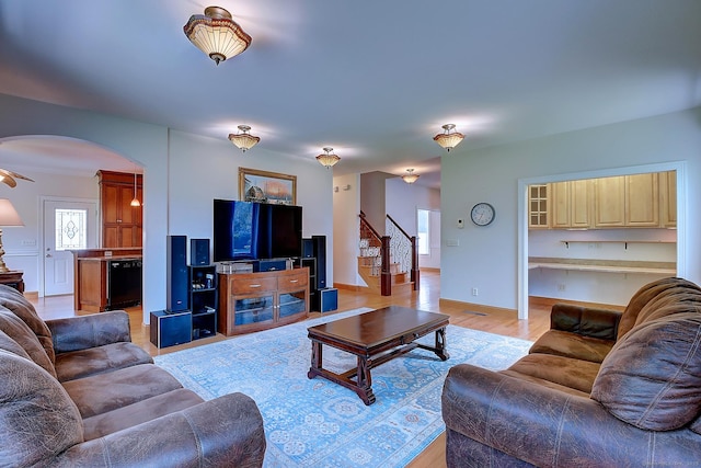 125 Waverly Dr, Newington, CT 06111 - living room with stairway, arched walkways, and light wood finished floors