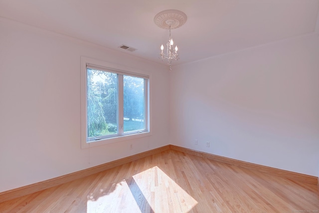 125 Waverly Dr, Newington, CT 06111 - spare room featuring a chandelier and light wood-style flooring