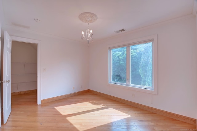 125 Waverly Dr, Newington, CT 06111 - empty room featuring a chandelier, light wood-style flooring, and crown molding