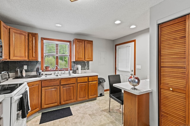 115 Town Farm Rd, East Haddam, CT 06423 - kitchen featuring white range with electric stovetop, brown cabinetry, light countertops, tasteful backsplash, and a textured ceiling