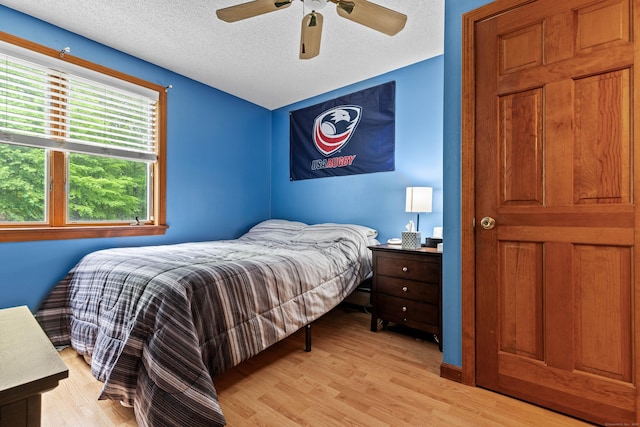 115 Town Farm Rd, East Haddam, CT 06423 - bedroom with light wood-style floors, a textured ceiling, and a ceiling fan